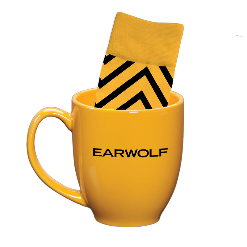 Yellow mug with the text EARWOLF and a pair of black and yellow striped socks partially inside.