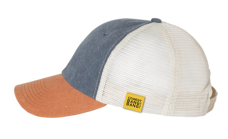 Trucker hat with a blue front, brown brim, mesh back, featuring a yellow tag that says 'Comedy Bang! Bang!'