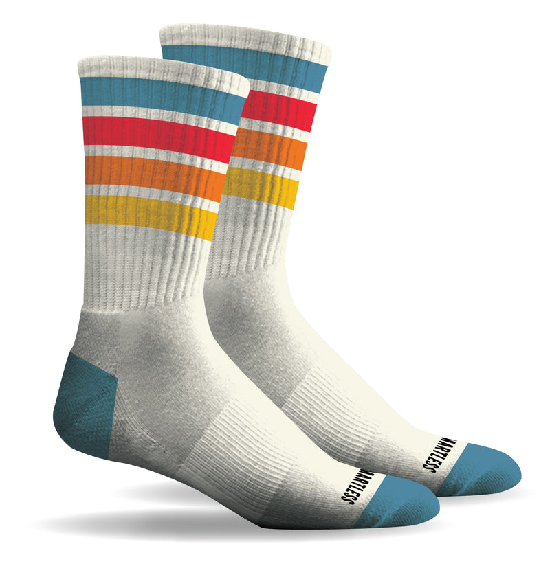 Pair of colorful striped socks with a white base and blue heel featuring horizontal stripes top down: blue, red, orange, and yellow. 'SMARTLESS' branding above the blue toe box.