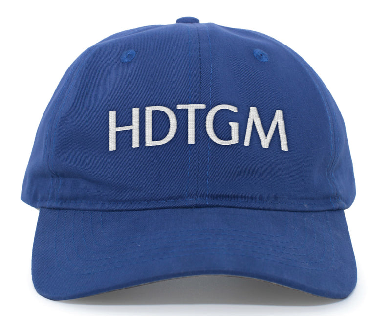 A royal blue baseball cap with white embroidered text on the front that reads 'HDTGM' in bold, uppercase letters. The hat has a curved brim and a structured six-panel design.