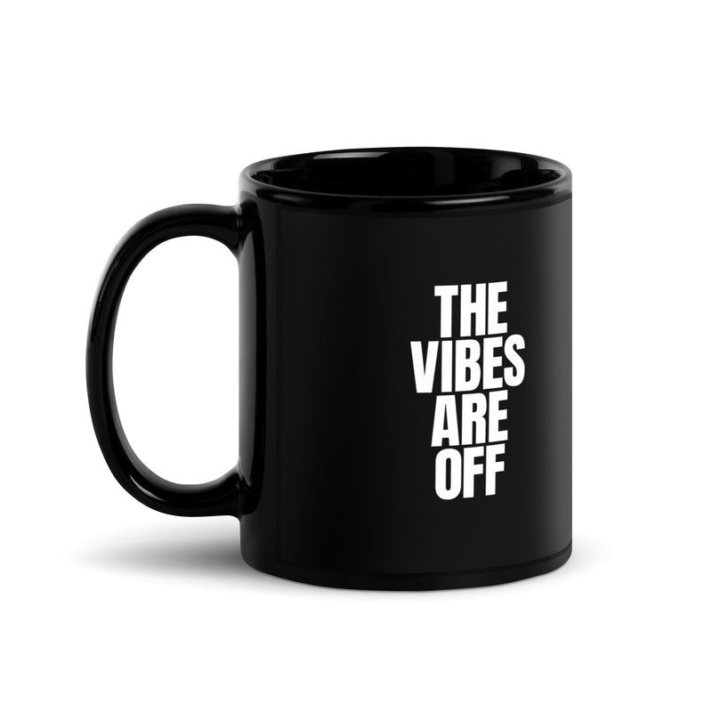 11 ounce black glossy mug with the 'THE VIBES ARE OFF' in bold white text, similar to the previous designs, but shown from a slightly different angle with the handle on the left.