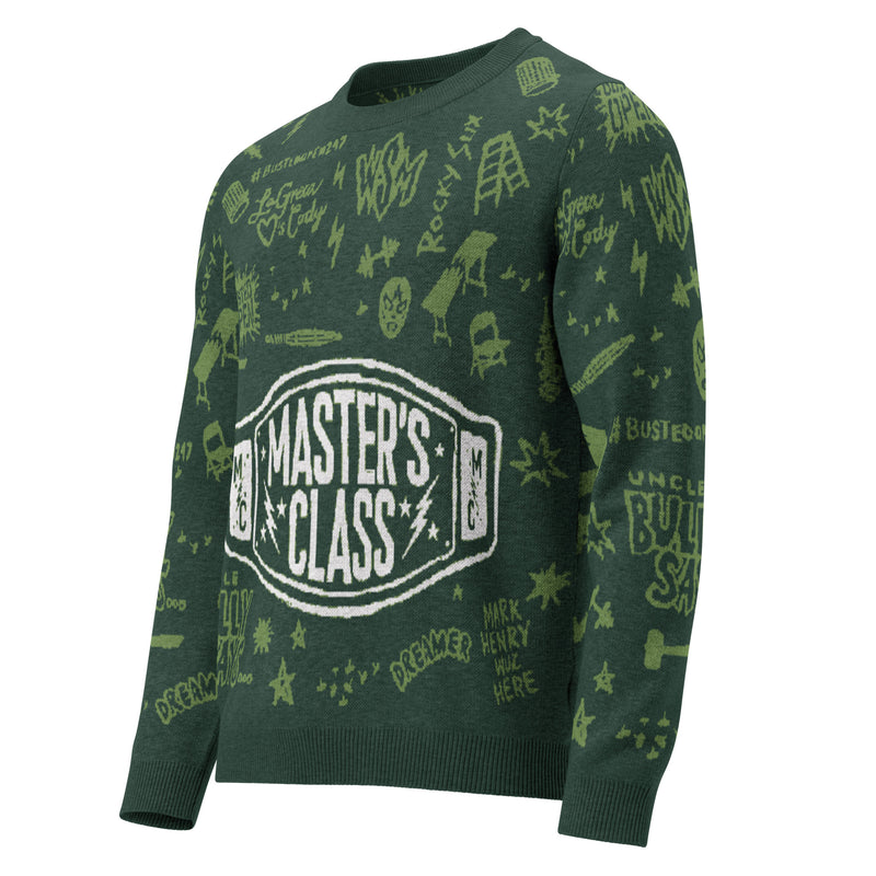 A green sweater featuring various designs and text, including 'MASTER'S CLASS' in a central belt-like graphic. The patterns include stars, doodles, and phrases related to wrestling and inspiration.