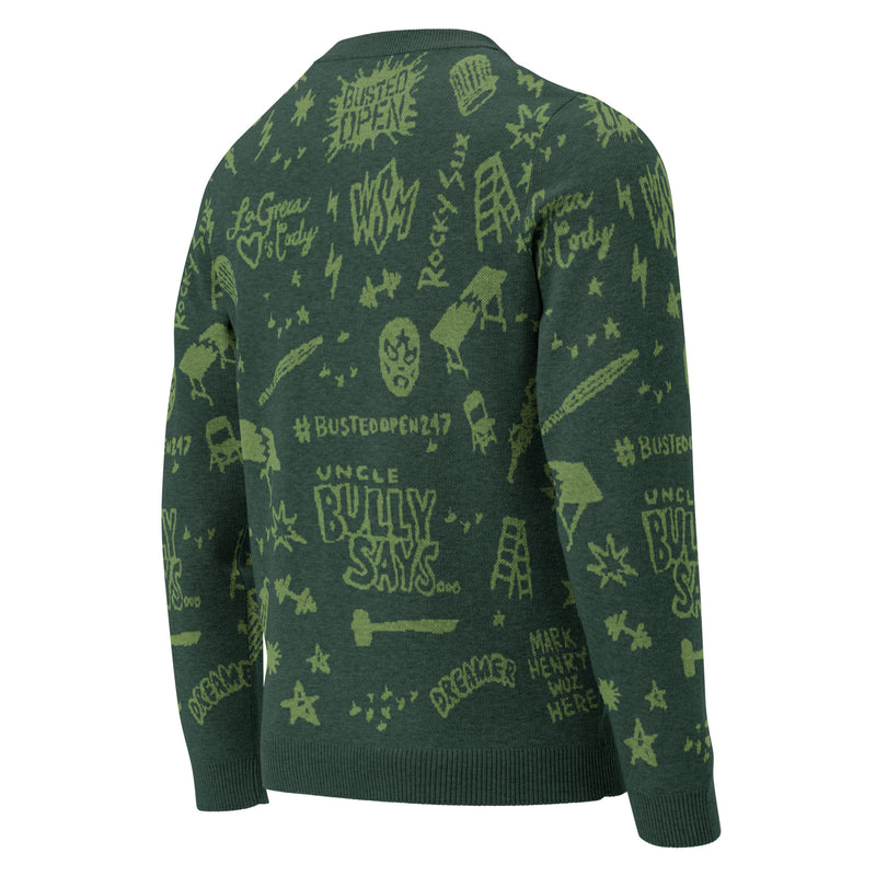 Back of green sweater with a pattern of various text and graphics, including phrases like 'BUSTED OPEN,' 'UNCLE BULLY SAYS,' and icons related to wrestling.