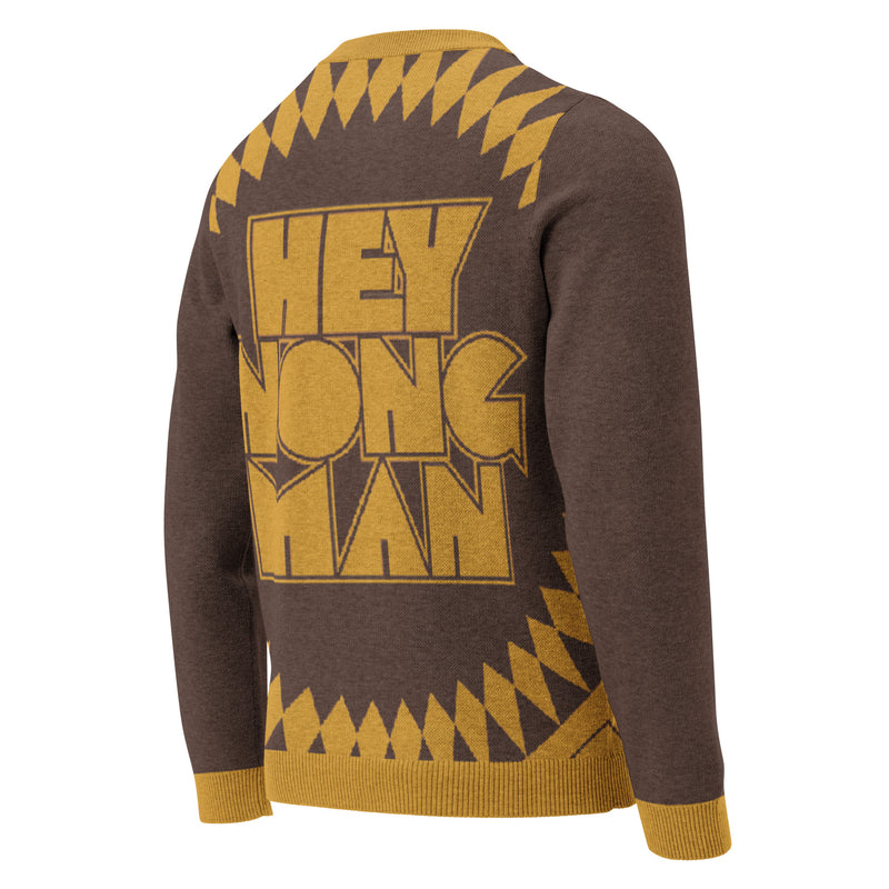 Sweater with 'HEY NONG MAN' printed in bold gold letters on a brown background, featuring geometric designs along the shoulders and bottom.