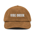 Cap in brown corduroy with the text VIBE CHECK embroidered in white.