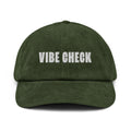 Green corduroy cap with the text VIBE CHECK embroidered in white on the front.