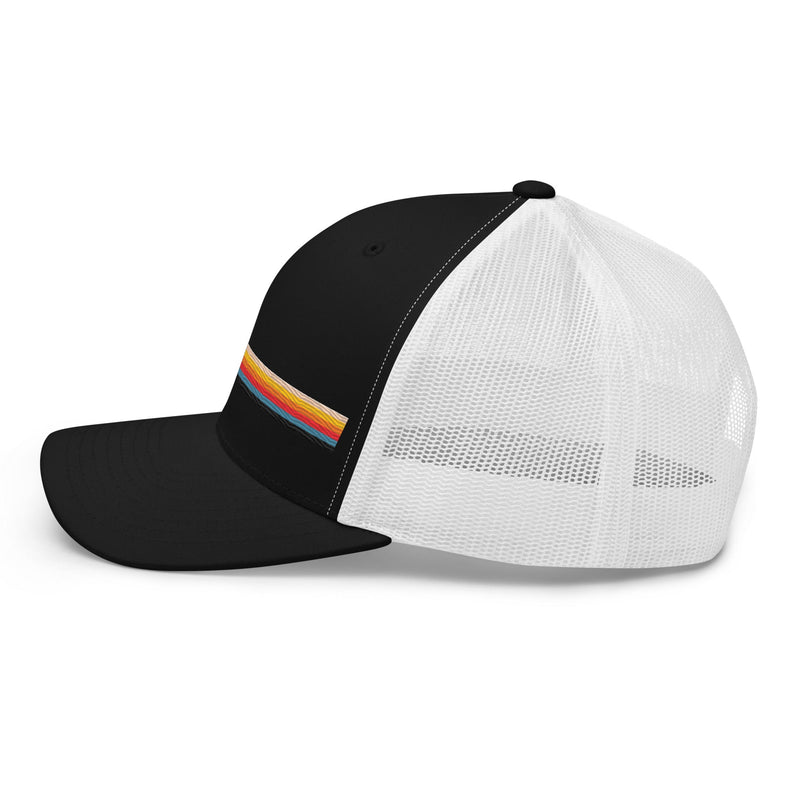 Black and white trucker hat with colorful striped design on the front. Side view.