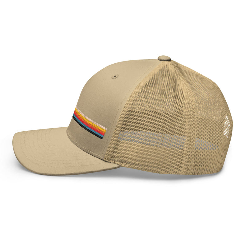 Beige trucker hat with a colorful striped design on the front. Side view.