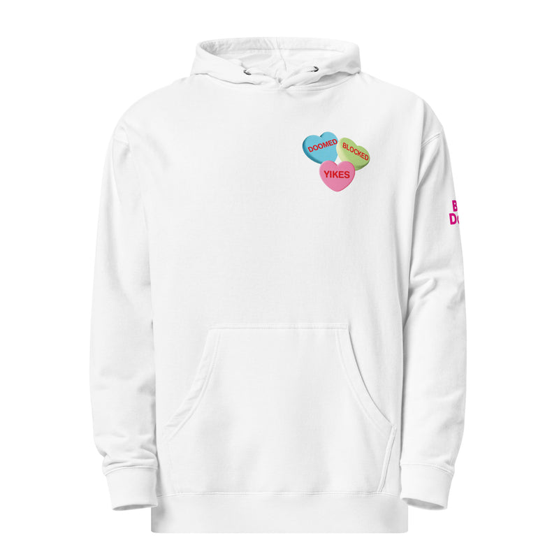 White hoodie with three colorful hearts that say 'DOOMED,' 'BLOCKED,' and 'YIKES' on left center. The left sleeve has pink text that reads 'BAD DATES.'