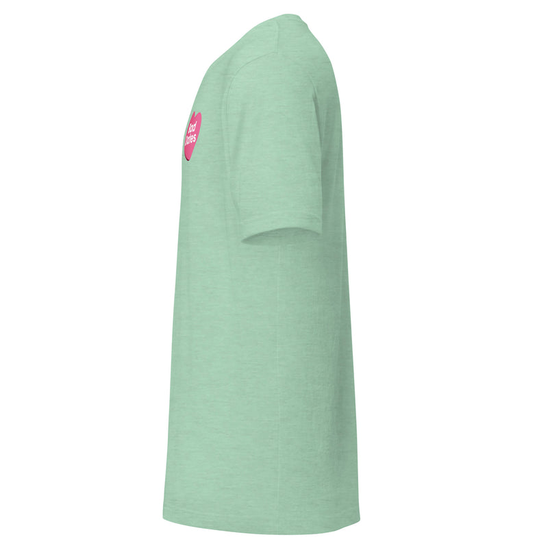 Side view of green t-shirt with a pink heart design on front.