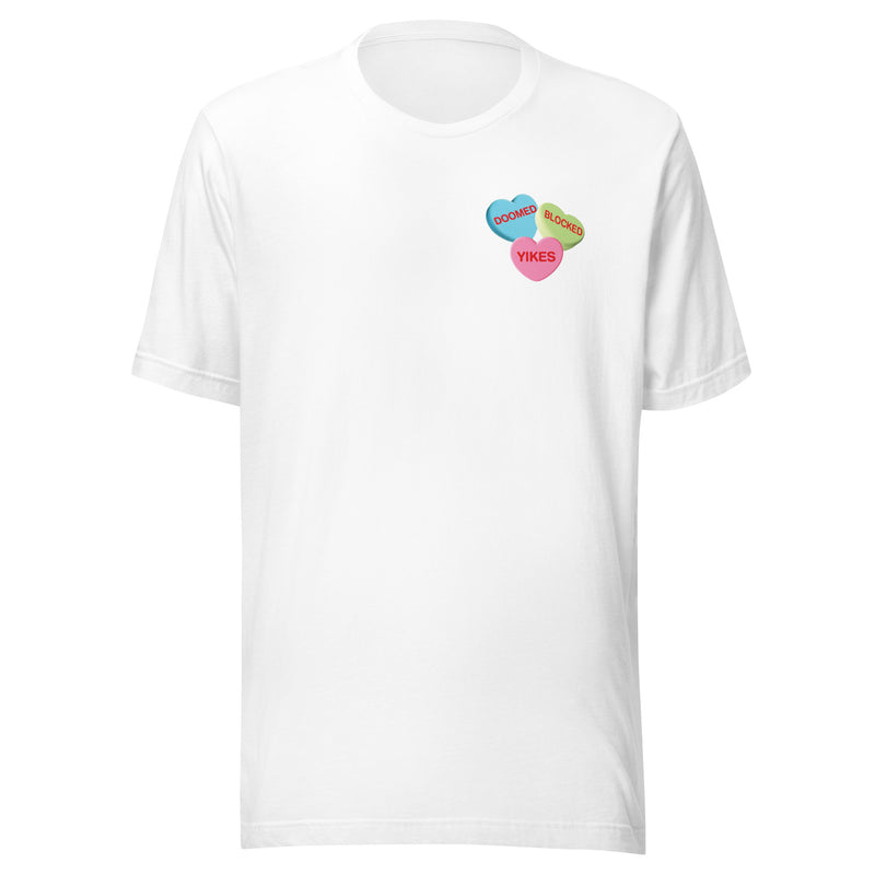 Front of white t-shirt with three hearts on the left chest, a blue heart with the word 'DOOMED', a green heart with the word 'BLOCKED' and a pink heart with the word 'YIKES'