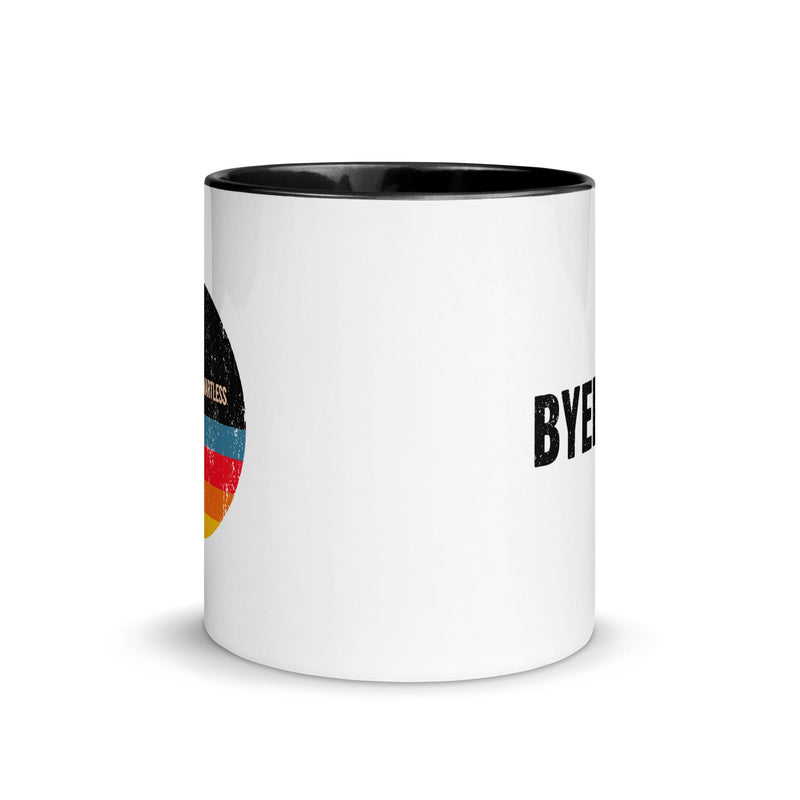 White mug with black interior with a design featuring a colorful circular graphic and black text on opposite sides.