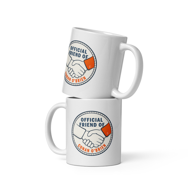 two white mugs displayed together featuring a handshake design and the text Official Friend of Conan O'Brien