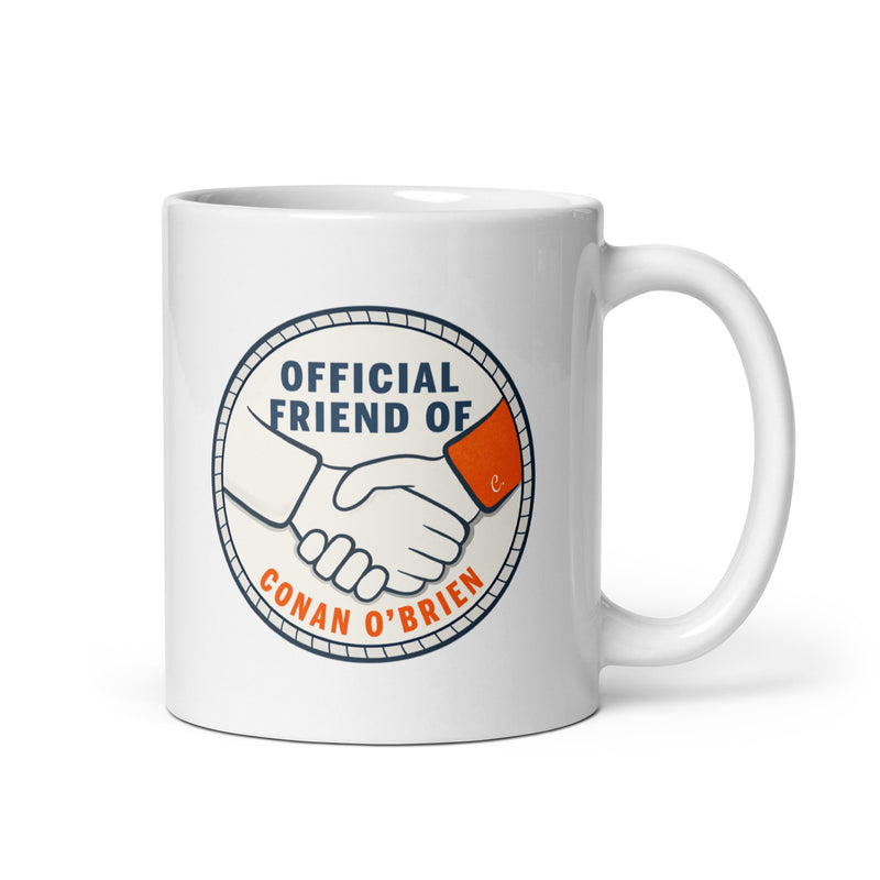 Ceramic mug with a handshake graphic and text stating Official Friend of Conan O'Brien.