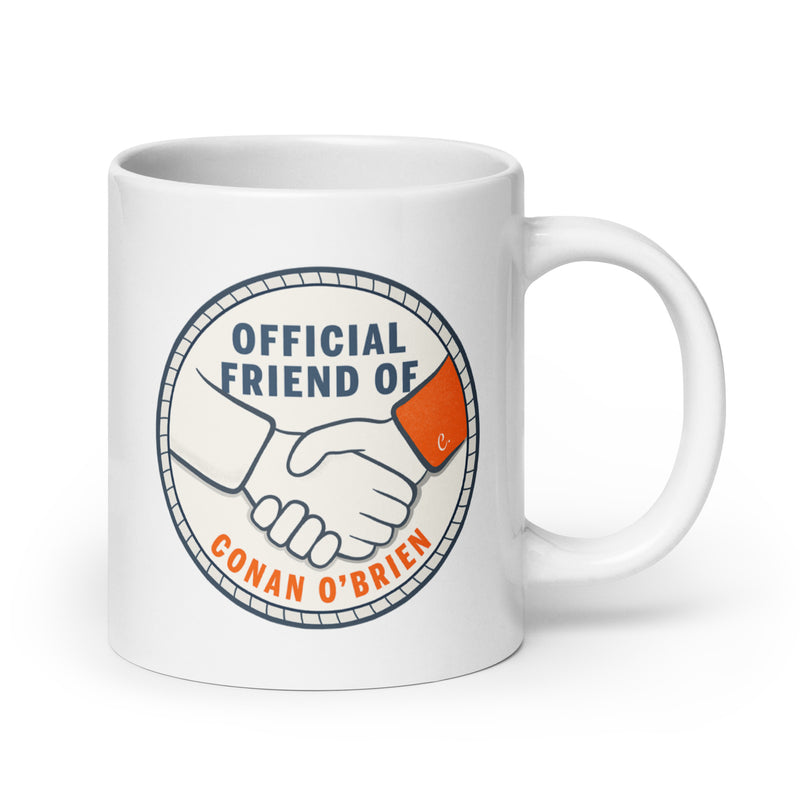 Ceramic mug with a handshake graphic and text stating Official Friend of Conan O'Brien.