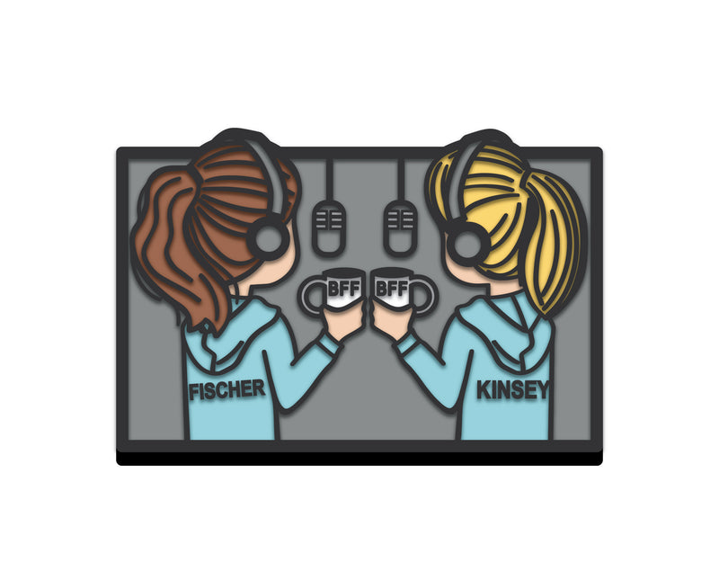 Rubber shoe charm of illustration of two girls in hoodies holding mugs, with microphones in the background, labeled 'Fischer' and 'Kinsey' celebrating friendship.