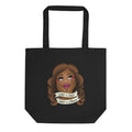 Black tote bag featuring the Illustration of a woman with long hair, resting her chin on her hands, with text banners reading 'What a treat, What a dream.'