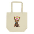 Cream colored canvas tote bag featuring the Illustration of a woman doing a cartwheelheart with heart and rainbow design elements.