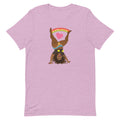 Pink t-shirt featuring the Illustration of a woman doing a cartwheelheart with heart and rainbow design elements.